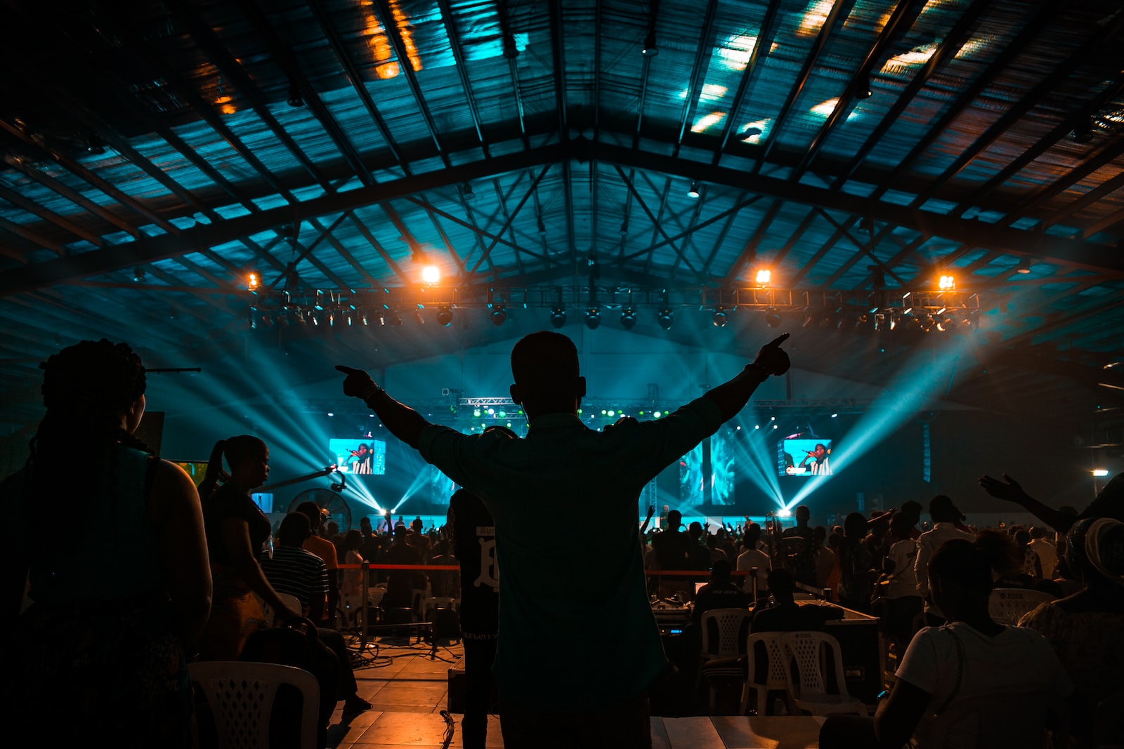 man in black jacket standing on stage