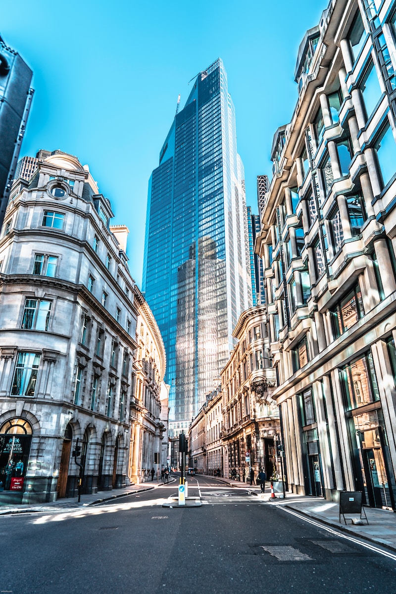 people walking on street between high rise buildings during daytime